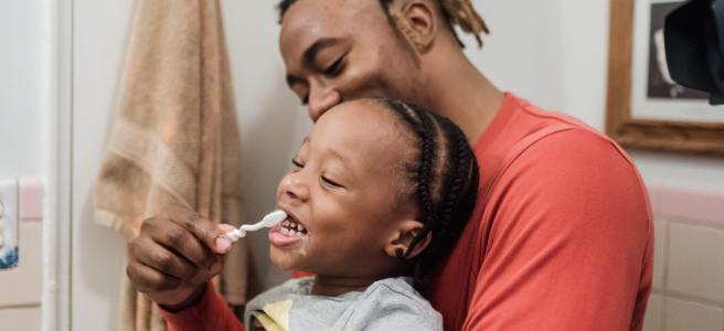 Laughing and Smiling Brushing Teeth With Daddy